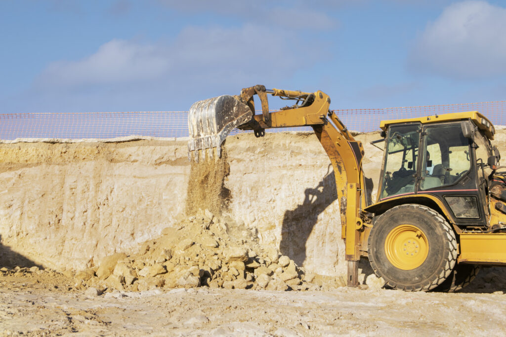 excavator digging ground day light